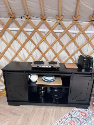 a black desk in a room with a wall at The Skye Yurt in Messing