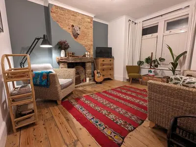 a living room with a fireplace and a red rug at Homely flat just off Leigh Broadway in Southend-on-Sea