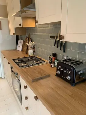 a kitchen counter with a stove and a toaster oven at Homely flat just off Leigh Broadway in Southend-on-Sea