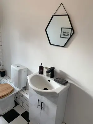 a bathroom with a white sink and a toilet at Homely flat just off Leigh Broadway in Southend-on-Sea