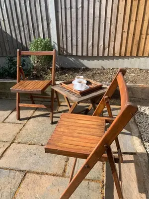 a table and a chair and a tea set on a patio at Homely flat just off Leigh Broadway in Southend-on-Sea