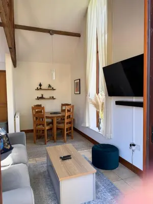 a living room with a couch and a table at Elm Barn in Diss