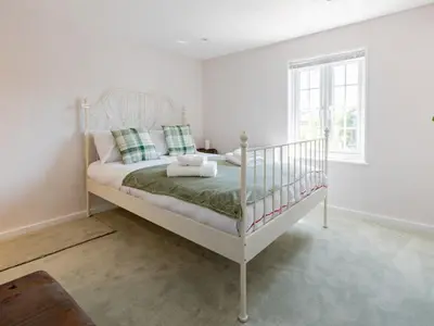 a bedroom with a white bed in a room at Magnolia Cottage your cosy Getaway Pass the Keys in Chelmsford