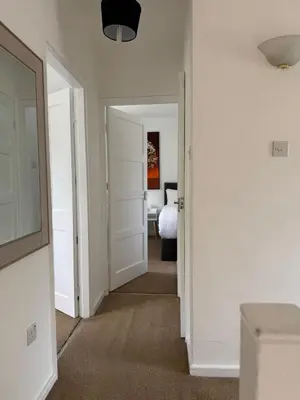 a hallway with a door leading to a bedroom at Holly Copse in Stevenage