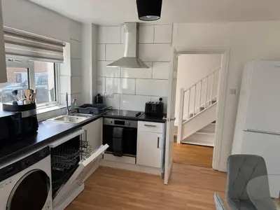 a kitchen with a sink and a stove at Holly Copse in Stevenage