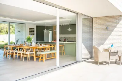 an open kitchen and dining room with a table and chairs at Heath House 4 in Thorpeness