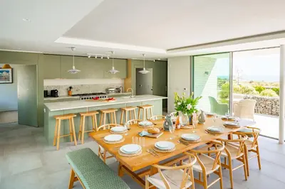 a kitchen and dining room with a wooden table and chairs at Heath House 4 in Thorpeness