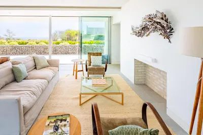 a living room with a couch and a fireplace at Heath House 4 in Thorpeness