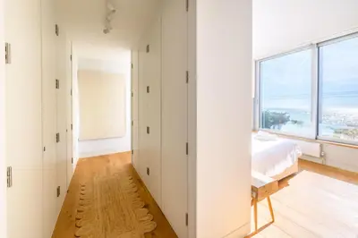 a bedroom with white walls and a large window at Heath House 4 in Thorpeness