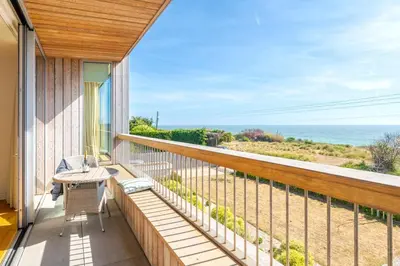 a balcony with a view of the ocean at Heath House in Thorpeness