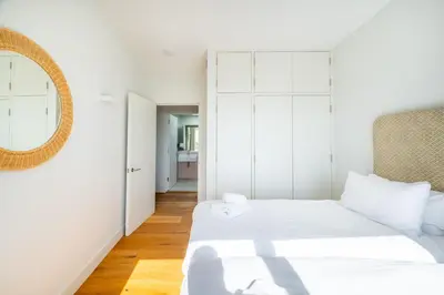 a bedroom with two beds and a mirror at Heath House in Thorpeness