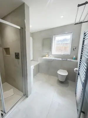 a bathroom with a shower and a toilet and a window at Modern stylish house in Charming Fen Ditton Village in CBG
