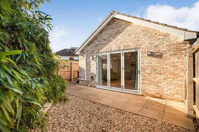 a brick house with a large sliding glass door at Modern stylish house in Charming Fen Ditton Village in CBG