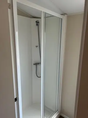 a shower with a glass door in a bathroom at Perfect days away - 3 bedroom 1 shower with decking & bedding in Colchester