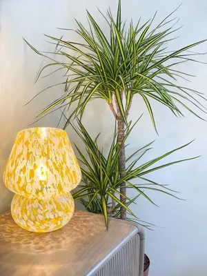a lamp and a plant on top of a table at Very best location - Luxury boutique apartment by river and historic city centre in Cambridge