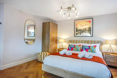 a bedroom with a large bed with two pillows at Very best location - Luxury Studio by river and historic city centre in Cambridge