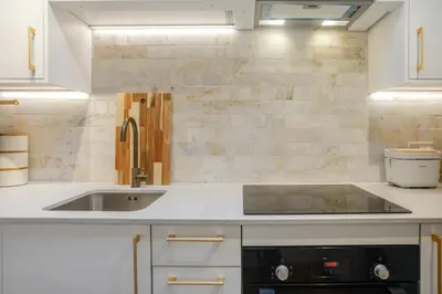 a kitchen with a sink and a stove at Very best location - Luxury Studio by river and historic city centre in Cambridge