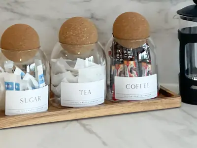 a shelf with two glass jars with tea and coffee at Cute and Spacious 1 Bed House by Station and River in Cambridge