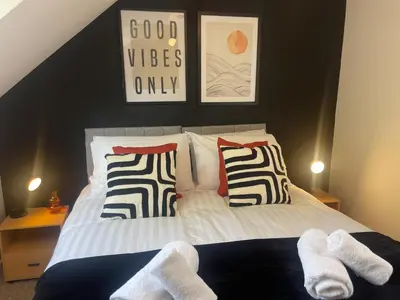 a bedroom with a bed with white socks on it at Cute and Spacious 1 Bed House by Station and River in Cambridge