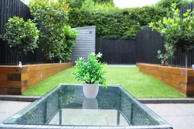 a plant sitting on a glass table in a garden at Spotless Two-Bedroom Home with Garden and Parking in Stevenage