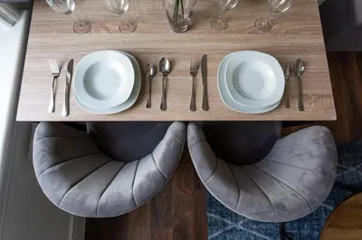 a table with plates and utensils on top of a chair at 1 Bed Apartments, 2 Mins to Beach, Sleeps 4 in Southend-on-Sea