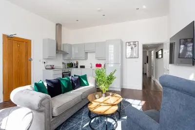 a living room with a couch and a table at 1 Bed Apartments, 2 Mins to Beach, Sleeps 4 in Southend-on-Sea