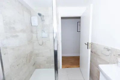a bathroom with a shower and a sink at First Class Flat in Brandon