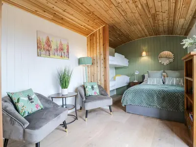 a bedroom with a bed and two chairs in it at Woodpecker in Cambridge