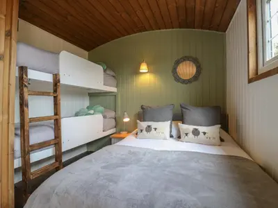 a bedroom with two bunk beds and a ladder at The Heron in Cambridge