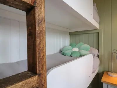 a room with a bunk bed with stuffed animals on it at The Heron in Cambridge