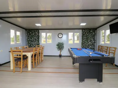 a room with a pool table and a dining room at The Heron in Cambridge