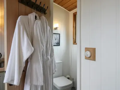 a bathroom with white towels hanging on a wall at The Heron in Cambridge