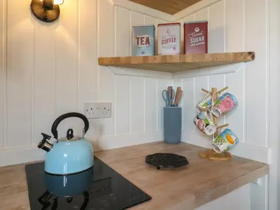 a tea kettle sitting on top of a stove in a kitchen at Barn Owl in Cambridge