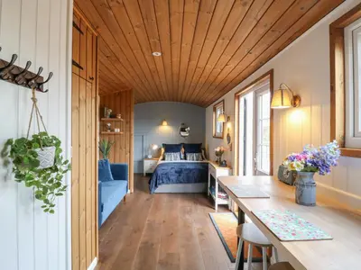 a bedroom with a bed and a table in a room at Barn Owl in Cambridge