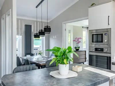 a kitchen and dining room with a table with a plant at Sunnyfields in Cambridge