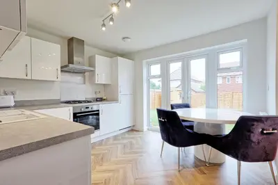 a kitchen with a table and chairs in a room at Luxury and cosy 2 bed entire house in Essex 20 mins from beach in Colchester