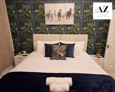 a bedroom with a white bed with a black and green wall at Mansion House Apartment,WIFI,FAMILY,CONTRACTORS in Newmarket