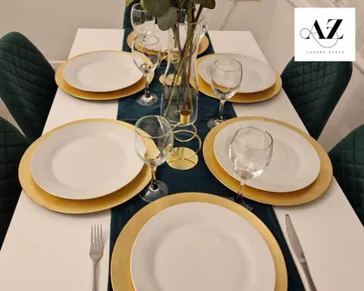 a table with white plates and wine glasses on it at Mansion House Apartment,WIFI,FAMILY,CONTRACTORS in Newmarket