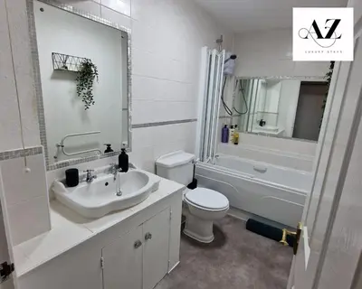 a bathroom with a sink and a toilet and a tub at Mansion House Apartment,WIFI,FAMILY,CONTRACTORS in Newmarket