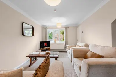 a living room with a couch and a table at 15 Mins to Sizewell C - Driveway Parking - Contractor Friendly - 2 Bedroom in Saxmundham