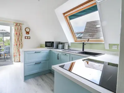 a kitchen with a sink and a window at Kingfisher in Ely