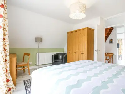 a bedroom with a bed and a desk and a chair at Kingfisher in Ely