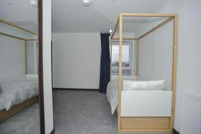 a mirror in a bedroom with a bed and a bed sqor at Seaview City Lodge , 2- bedroom flat with Parking in Southend-on-Sea