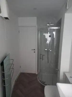 a bathroom with a shower with a glass door at The Southend Airport Lodge in Southend-on-Sea