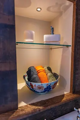 a bowl of yarn sitting on a shelf at Taper House - Cosy Medieval Cottage in Kersey