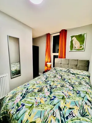 a bedroom with a bed with a colorful bedspread at Quirky and spacious 5 Bedroom and 3 bathroom house Sleeps 7 with free Parking in Basildon in Laindon