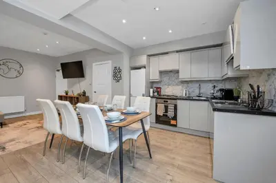a kitchen and dining room with a table and chairs at Weekly Deal- 4BDR House By Homestyles Hosts Short Lets & Serviced Accommodation Suffolk With Private En-Suite & Free Parking in Ipswich