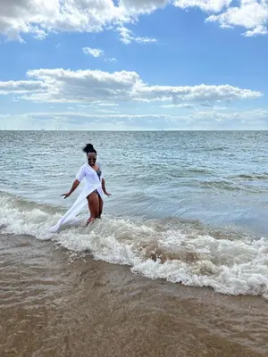a woman playing with a frisbee on the beach at Verb View 6 Berth Caravan St Osyth Clacton-On-Sea in Saint Osyth