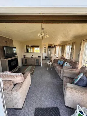 a large living room with couches and a television at Verb View 6 Berth Caravan St Osyth Clacton-On-Sea in Saint Osyth