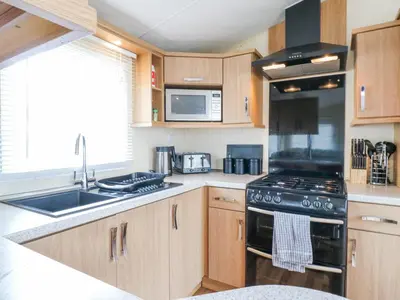 a kitchen with a stove and a sink at Bluebird in Clacton-on-Sea